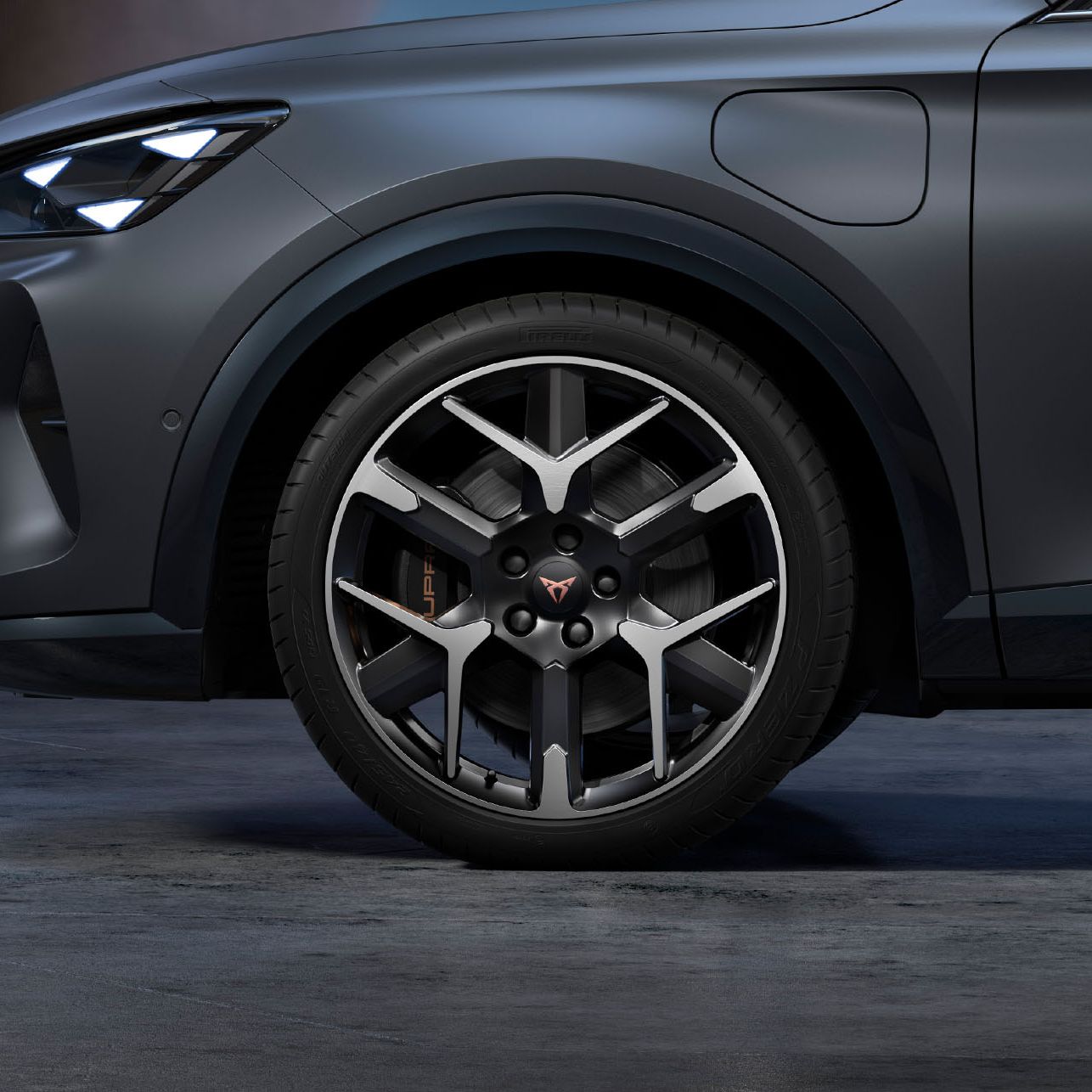 Vista frontal do CUPRA com jantes forjadas em prata e preto, pneus e faróis de assinatura.